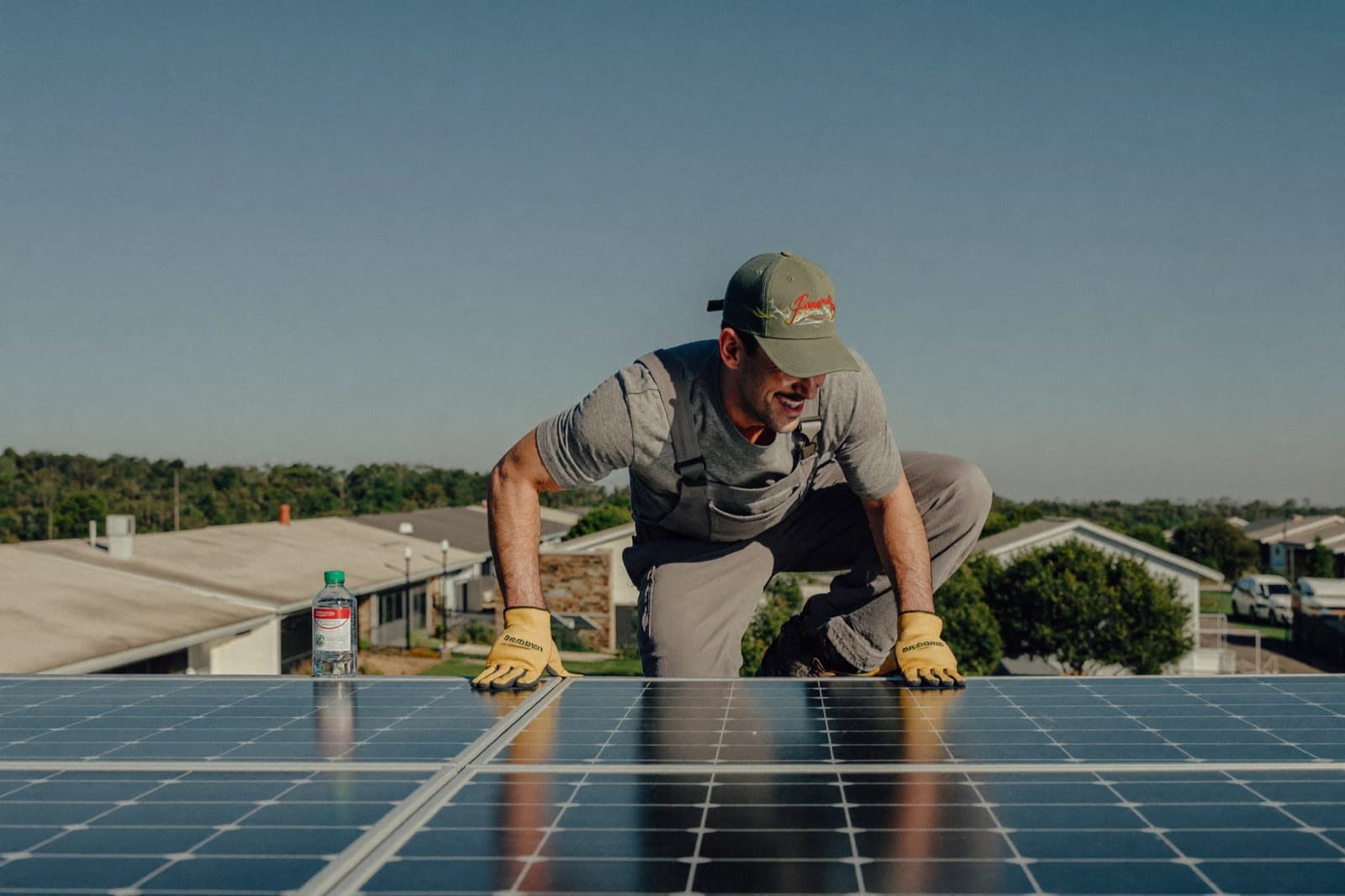A solar installer working on a residential rooftop array